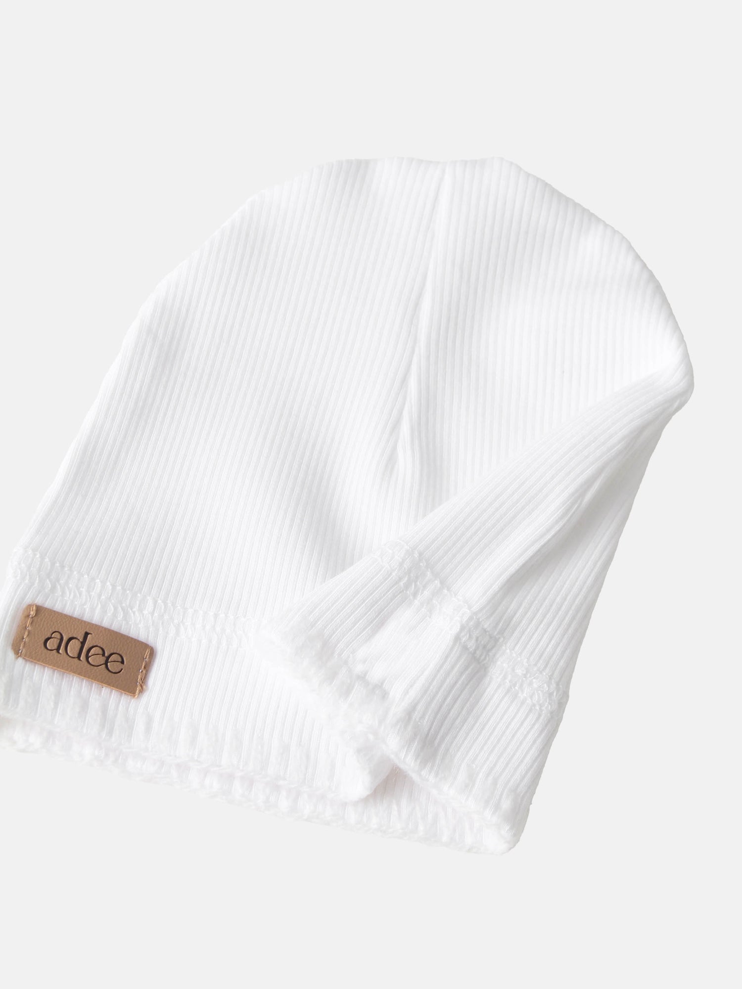 Legacy Stitch Hat - White, unisex beanie by Adee with corduroy-textured fabric and leather patch.