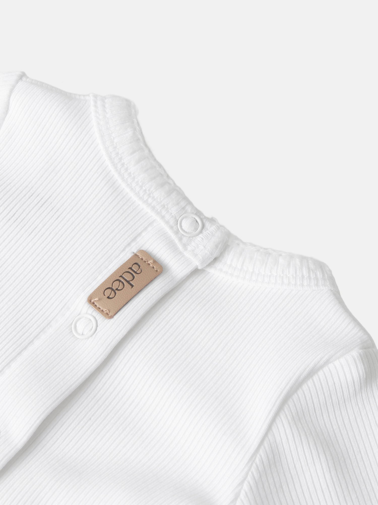 Legacy Stitch White layette set by Adee, white ribbed cotton with snap closures and beige label