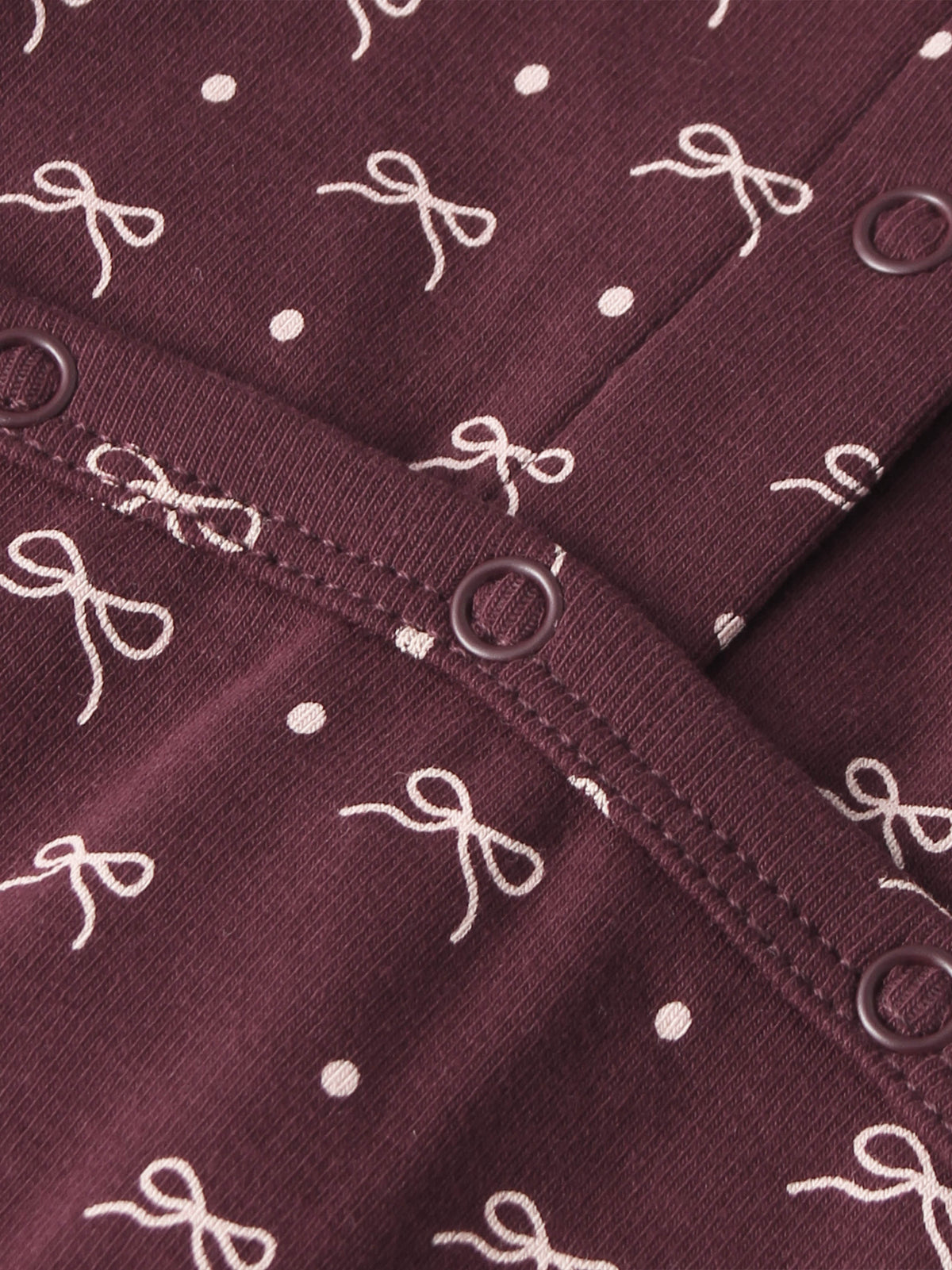 Burgundy Bow Stretchy fabric for girls by Adee with white bow pattern and metal eyelets