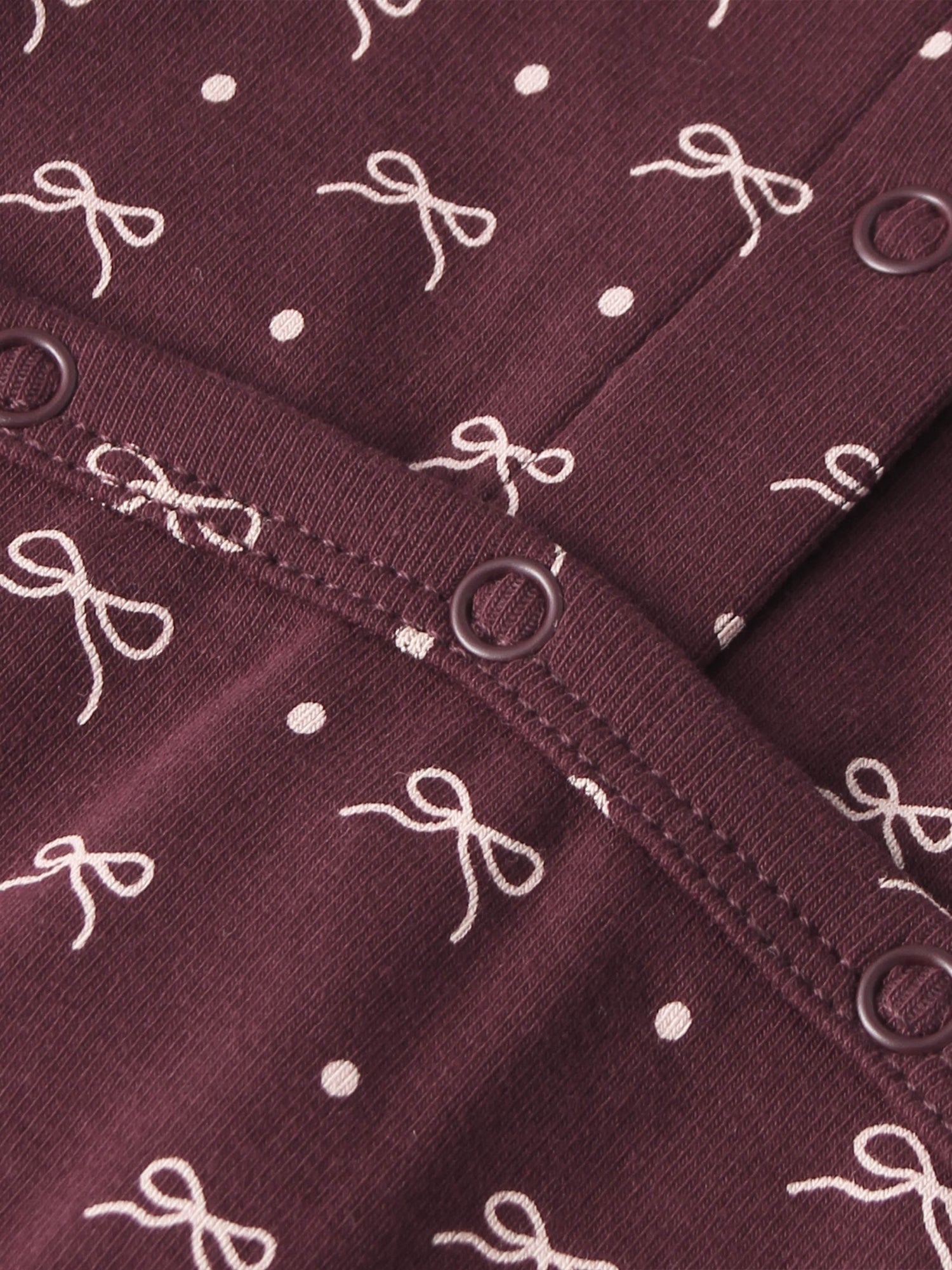 Burgundy Bow Stretchy fabric for girls by Adee with white bow pattern and metal eyelets