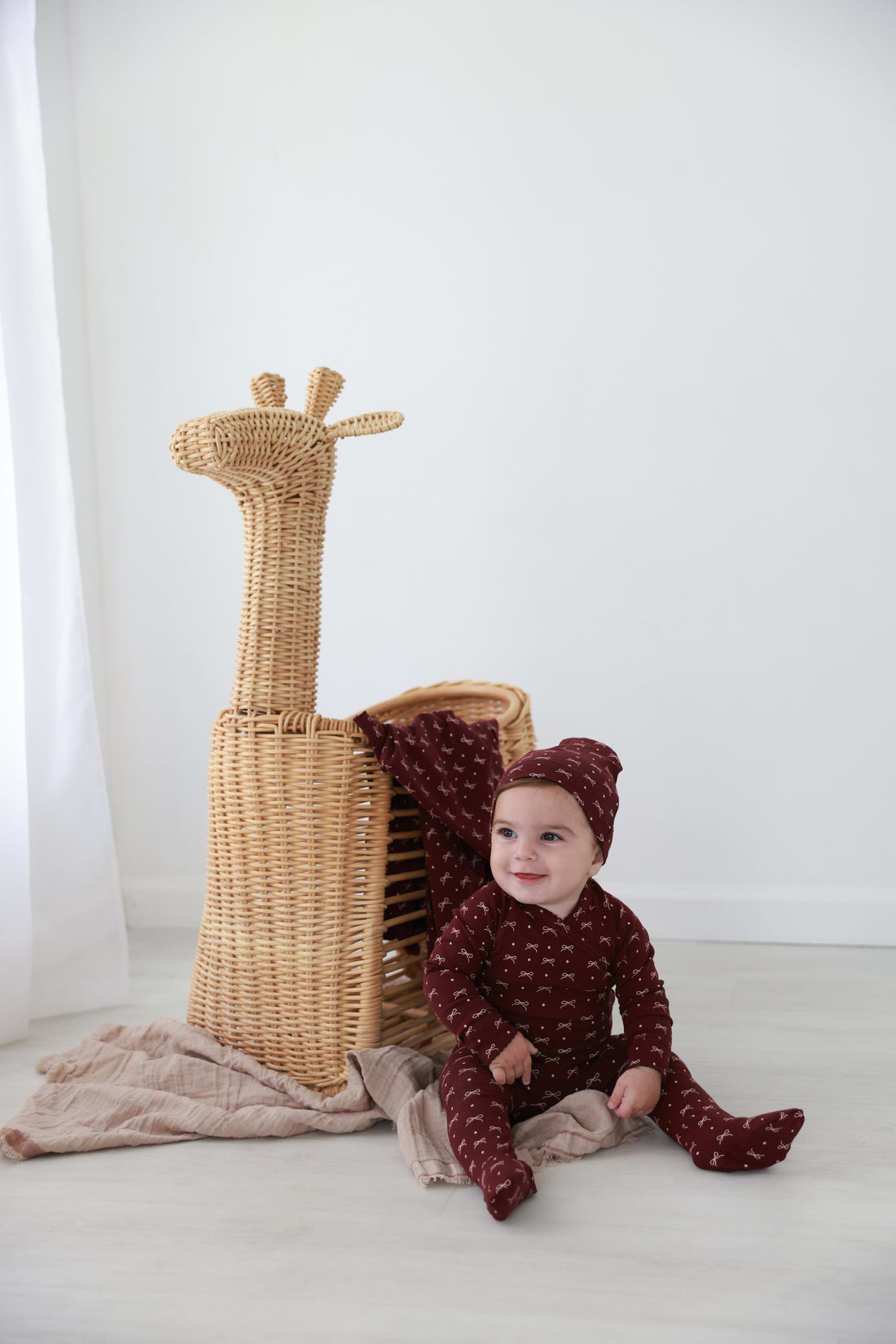 Adee Burgundy Bow layette set for baby girls, burgundy fabric with white bow print.