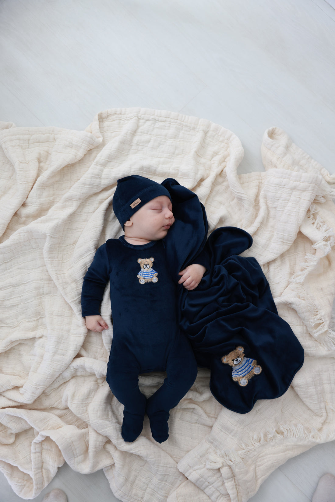 Embroidered Bear Navy layette set for boys by Adee; three-piece navy set with bear embroidery, hat and swaddle blanket.