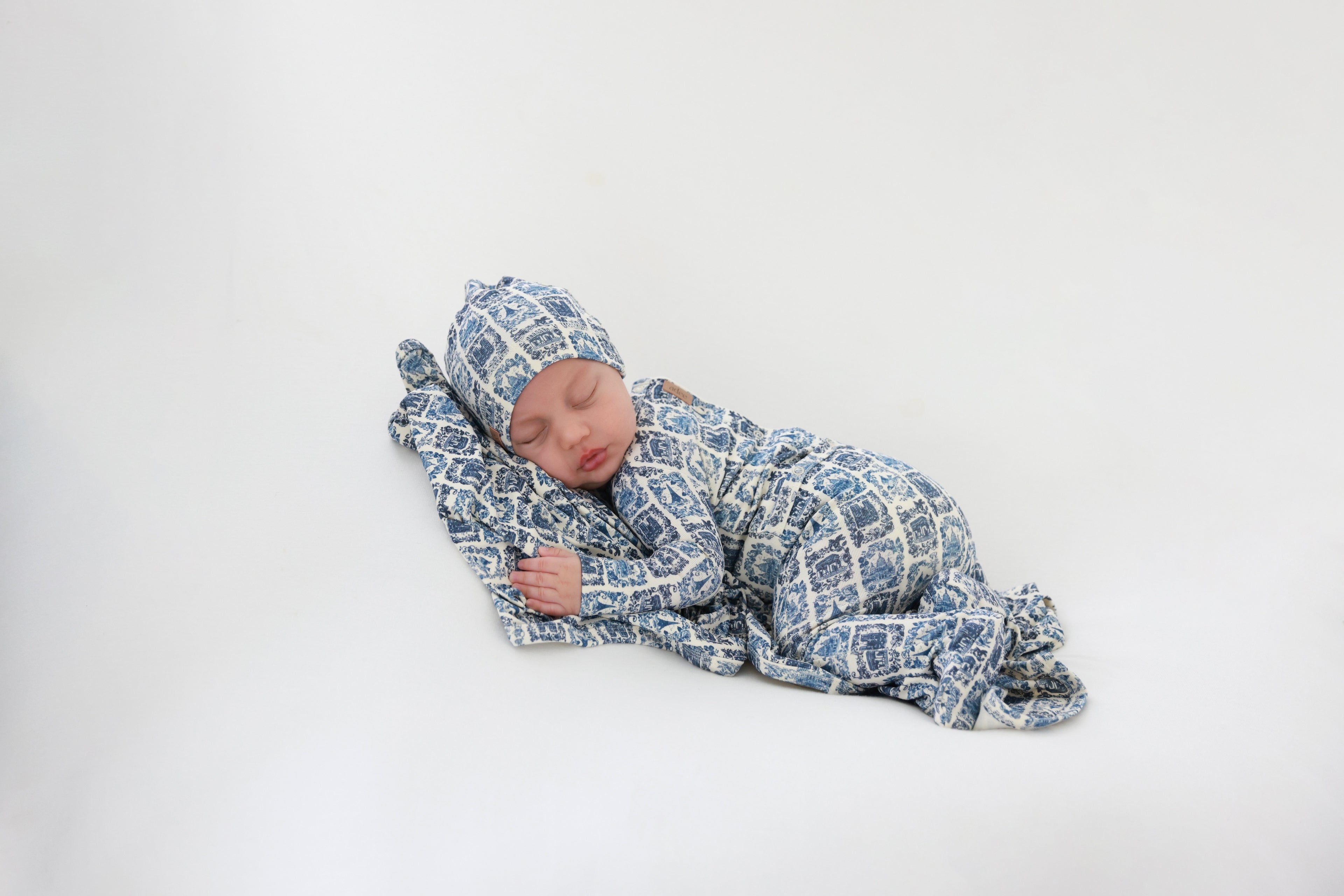 Blue Landmark Stretchy by Adee; boys stretchies outfit in blue landmark print worn by a sleeping baby.