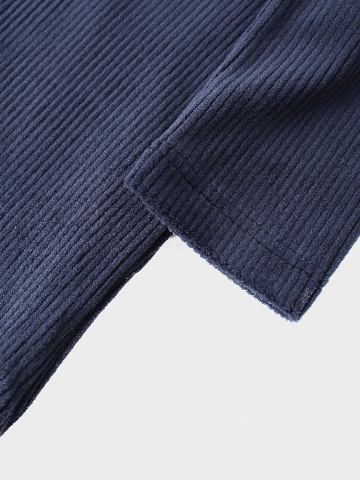 Close-up of navy ribbed velour fabric and pajama cuff.