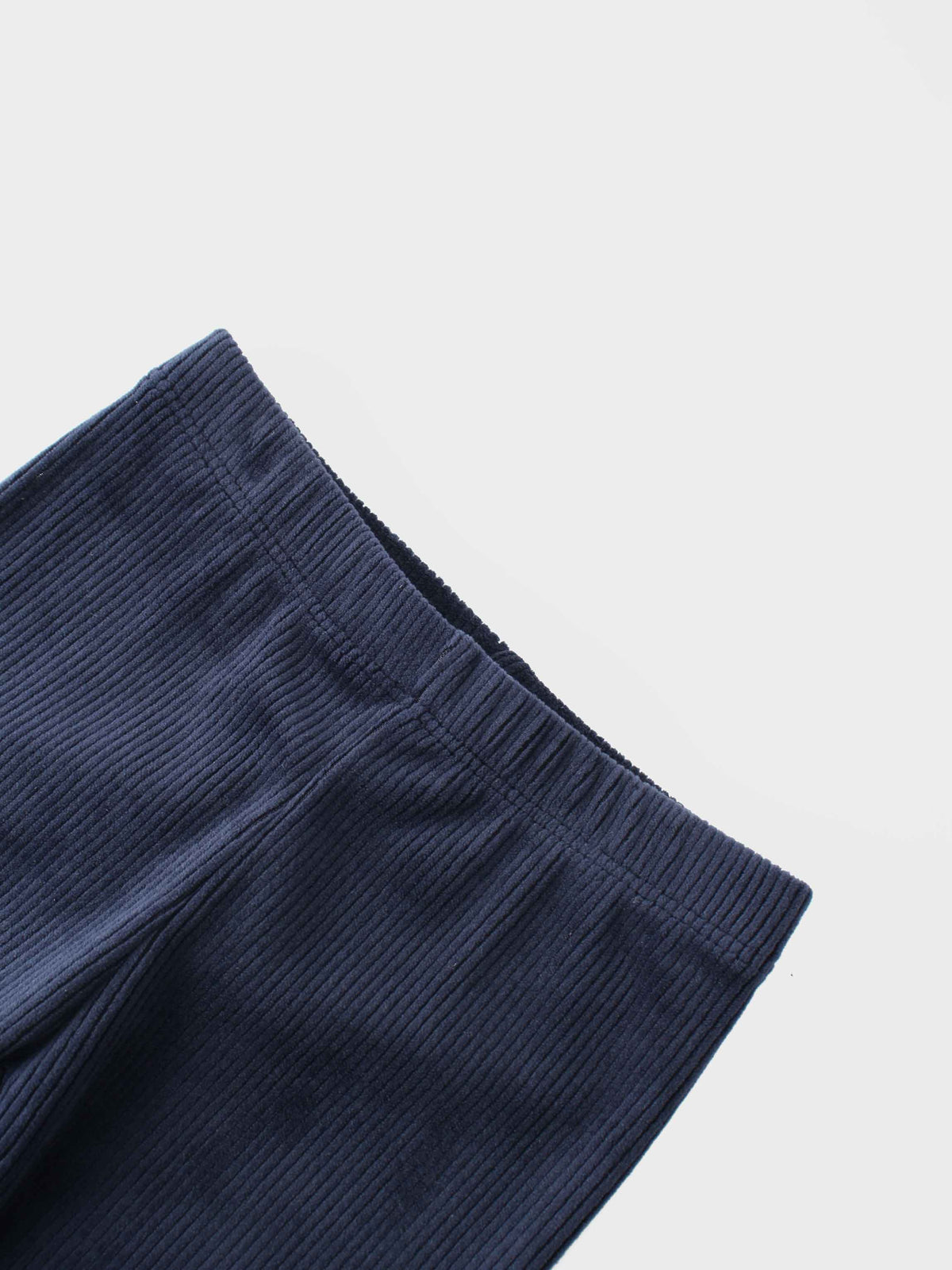 Close-up of navy ribbed velour pajama pants cuff.