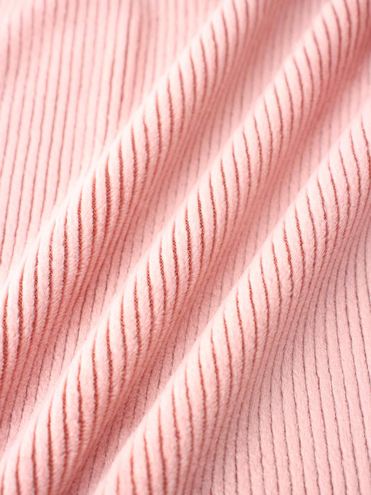 Ribbed velour pajama fabric for girls in pink; soft, cozy texture close-up