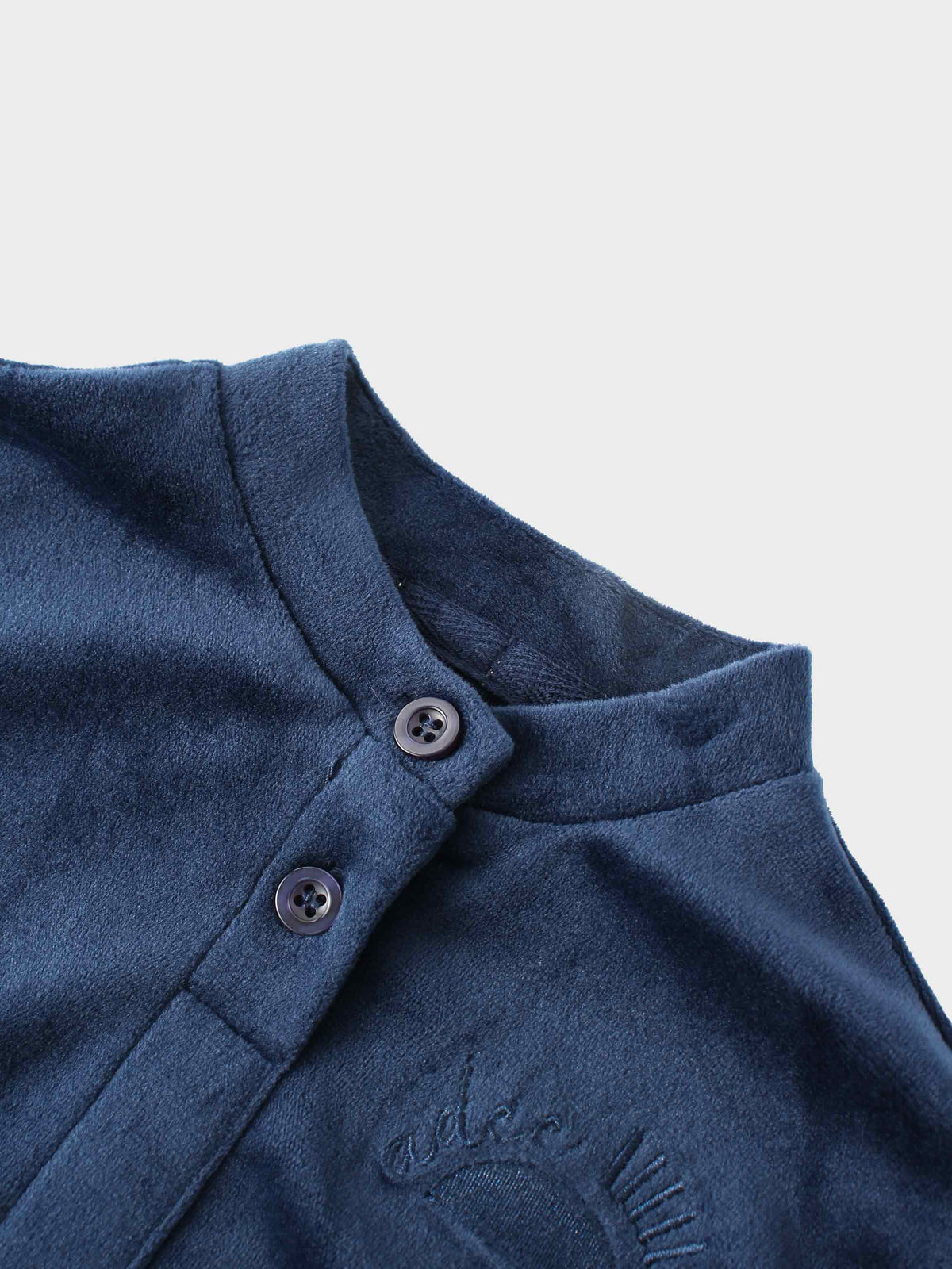 Navy velour bomber-style top with button placket, smooth neckline and cuffs for cozy kids sleepwear.