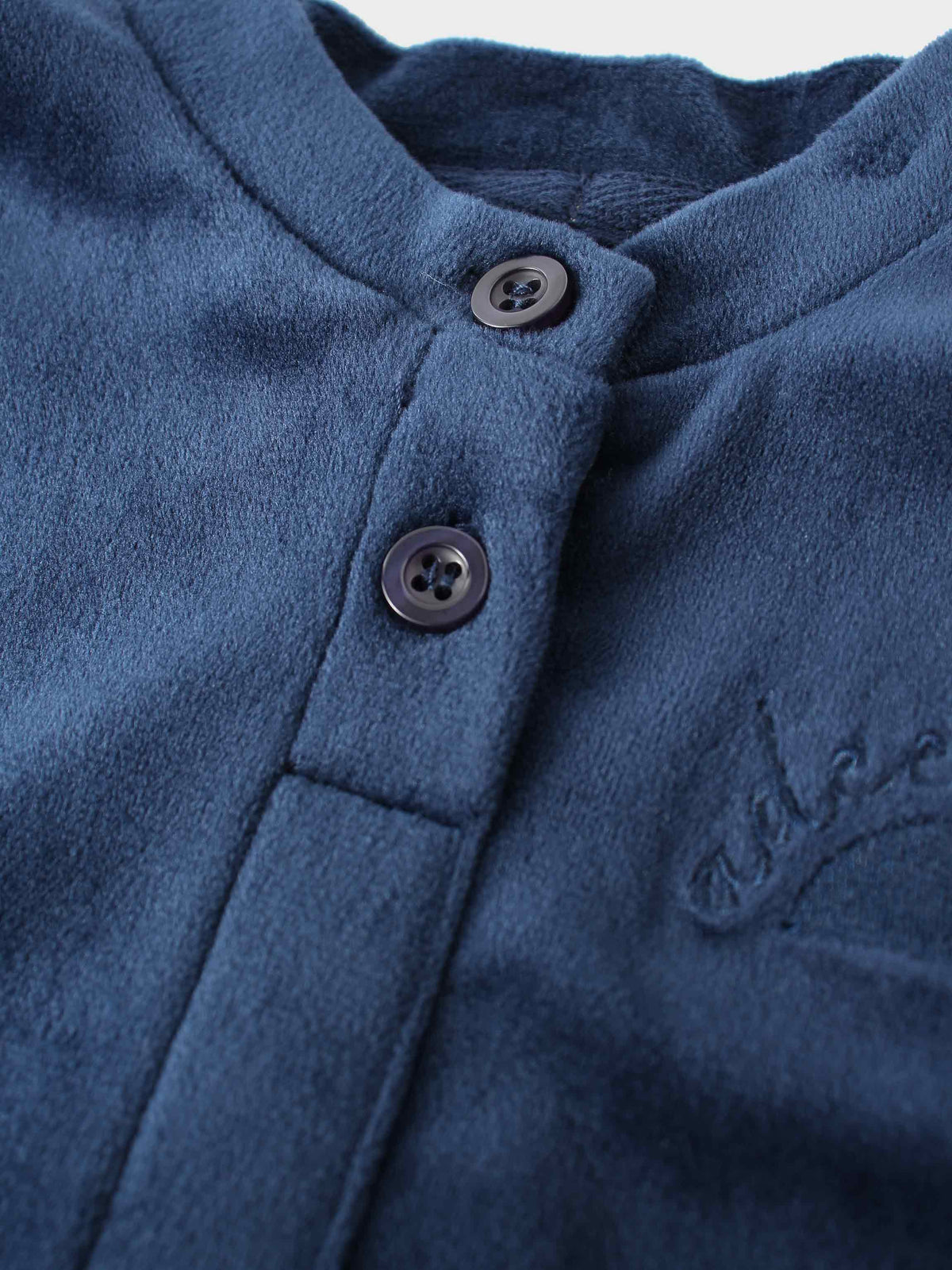 Navy velour bomber top with button placket on plush fabric.