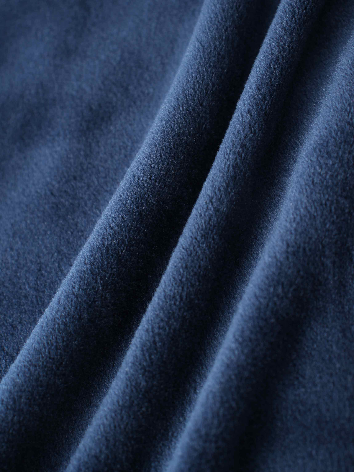 Close-up of plush navy velour fabric with soft folds, part of the Velour Bomber Set.