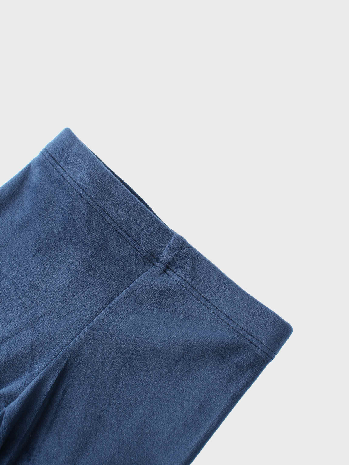 Navy velour bomber pajama sleeve close-up with neat cuff seam.