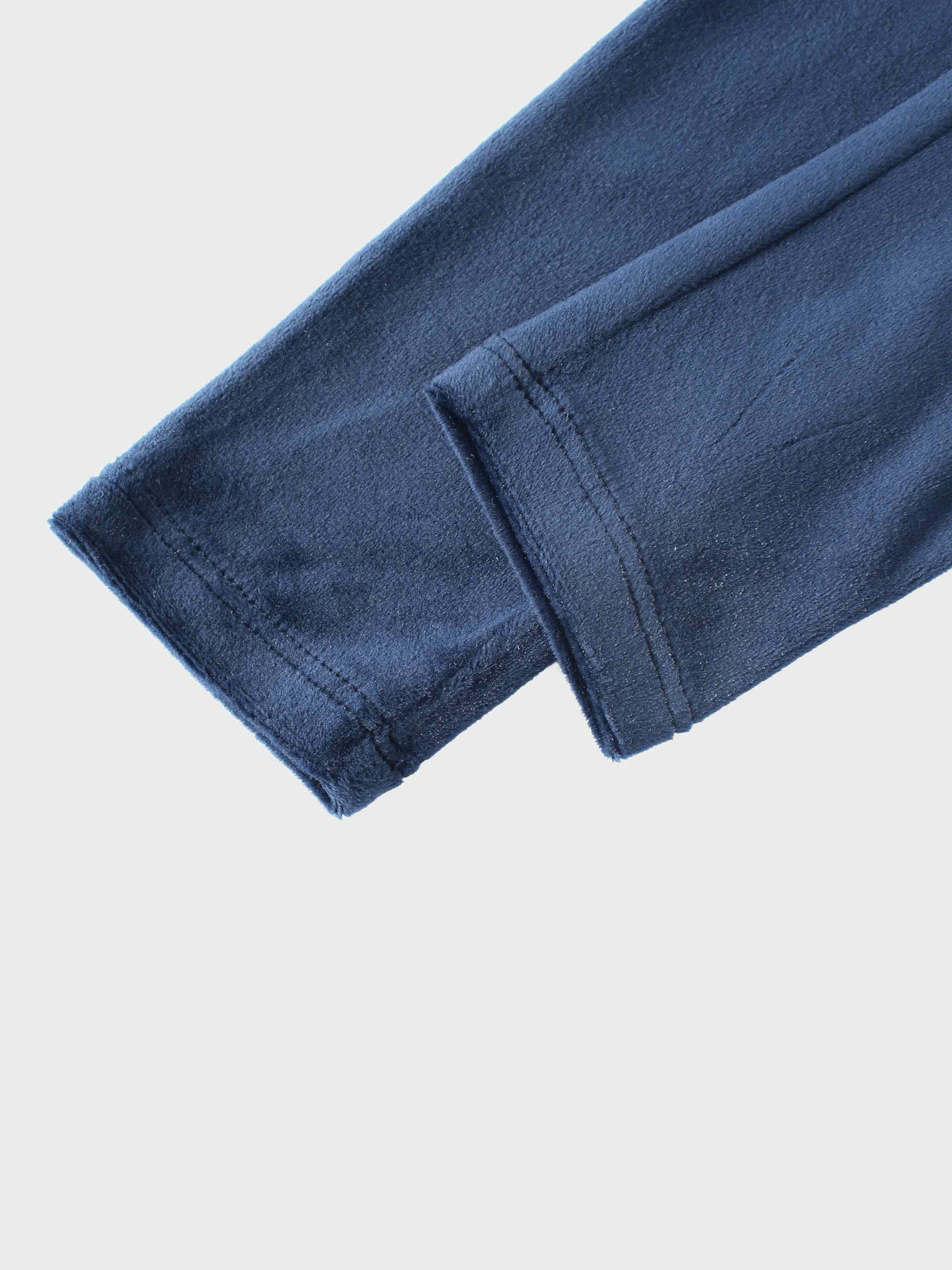 Navy velour bomber pajama sleeve with folded cuff.