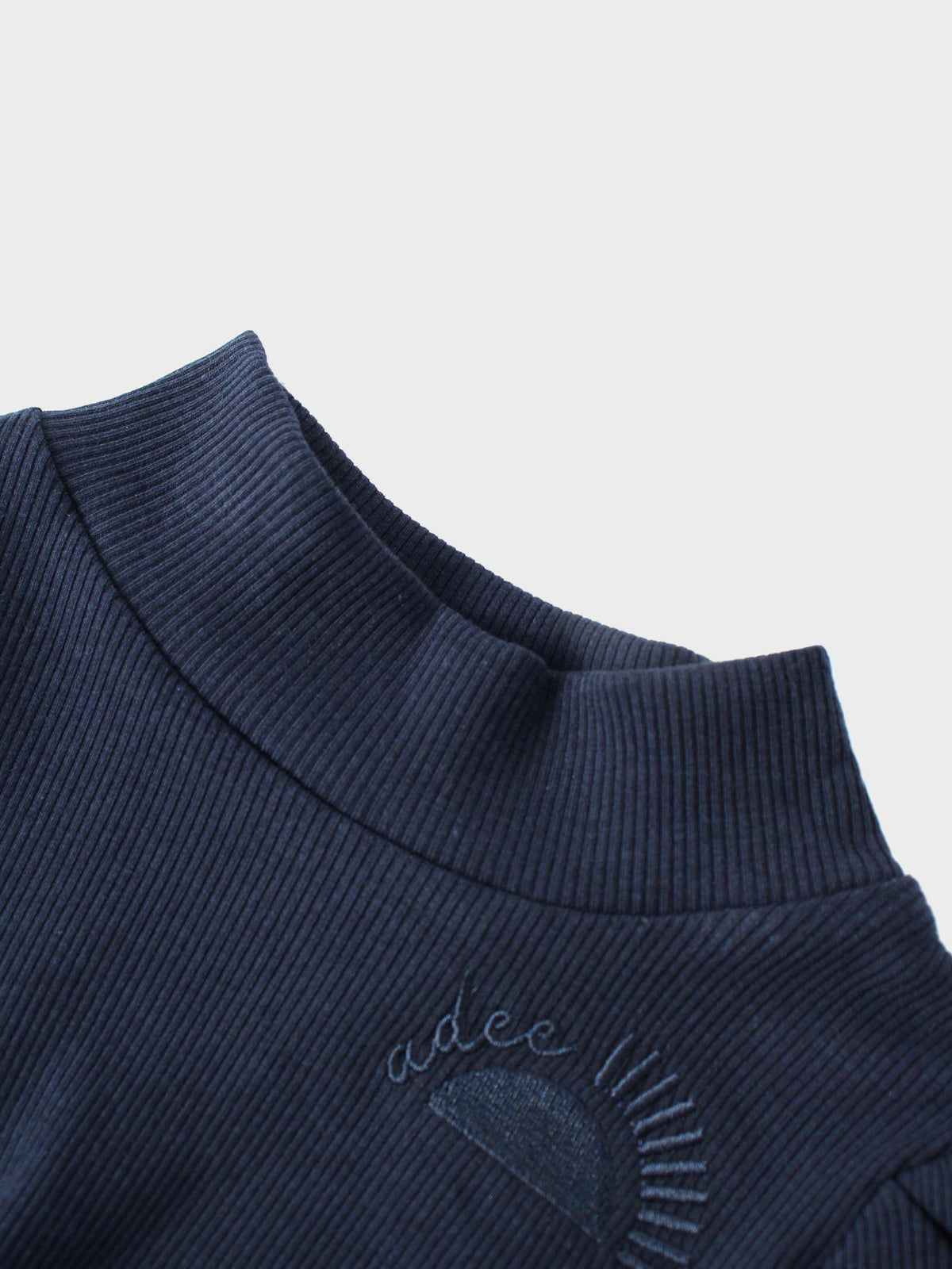 Ribbed navy knit little girls set by Adee; neckline shows Adee script embroidery
