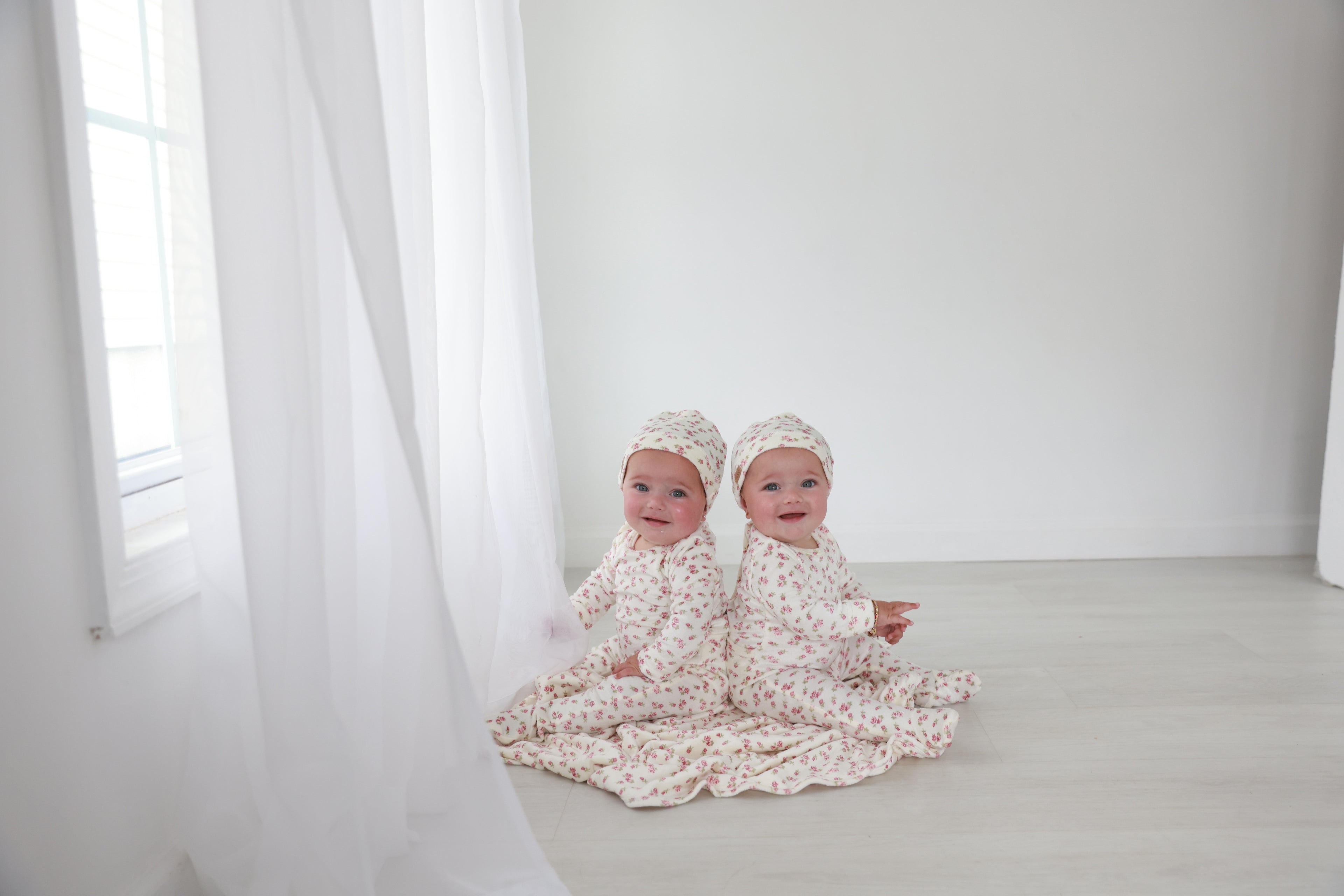 Tiny Blossom Stretchy girls stretchies in floral print, Adee brand, worn by twin babies