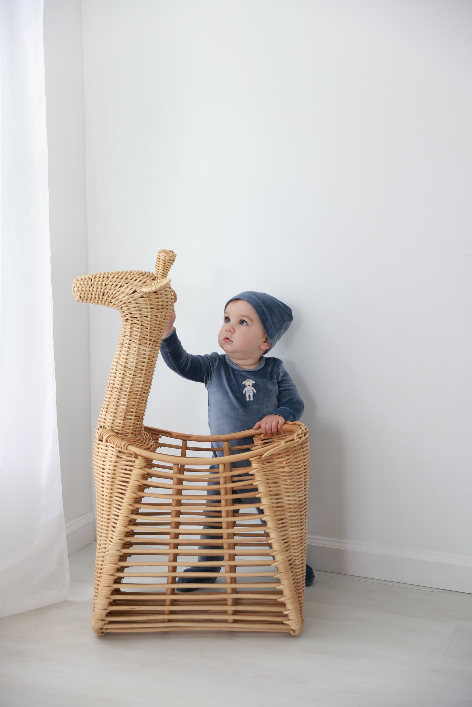 Baby Lamb Stretchy, blue boys stretchies in a wicker basket
