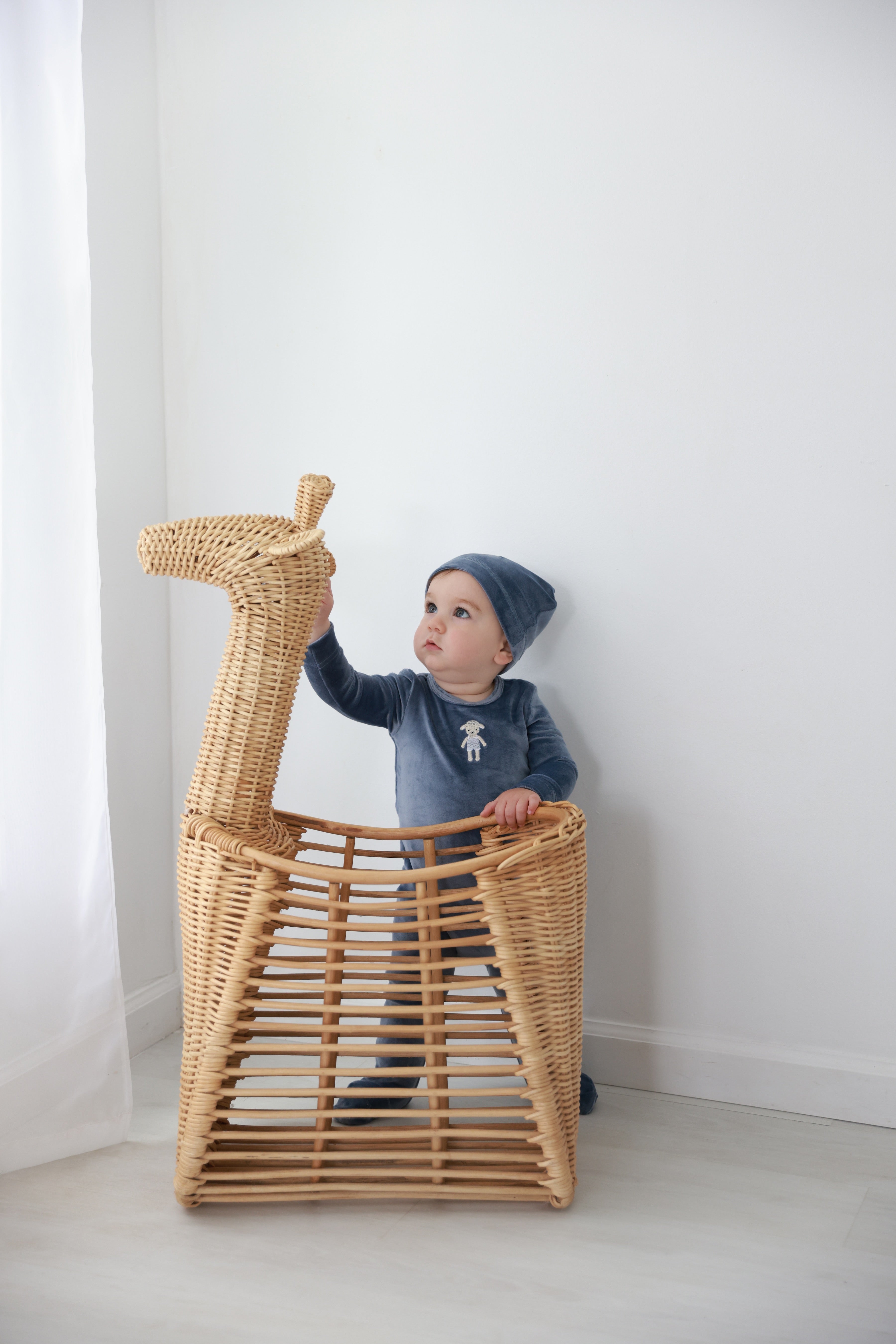 Baby Lamb Stretchy, blue boys stretchies in a wicker basket