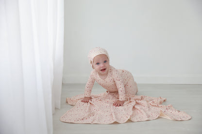 Garden Sprinkles Stretchy girls stretchies by Adee in pink floral print worn by a baby.