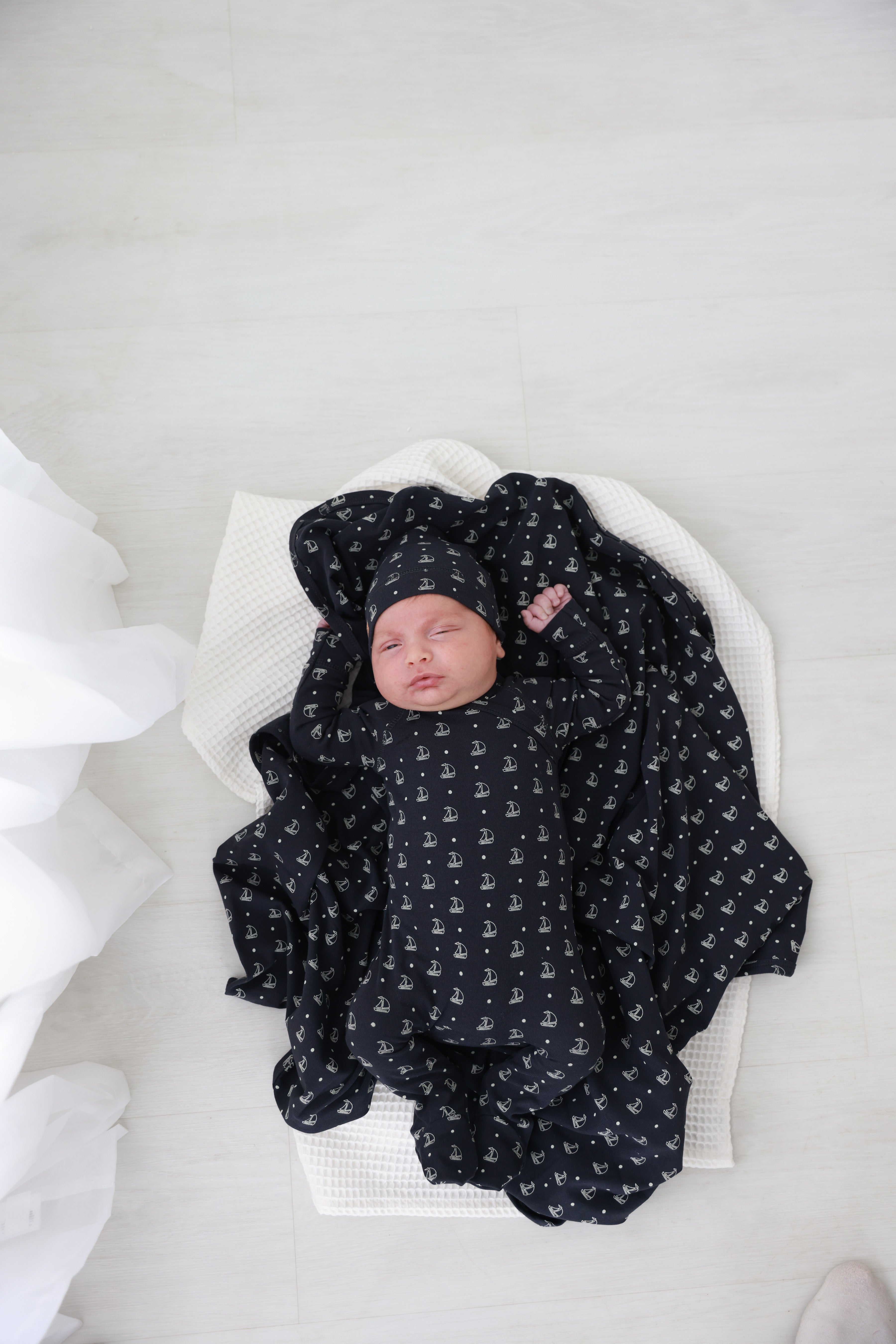 Harbor Dot Layette Set for boys by Adee; navy baby outfit with white sailboats and matching hat.