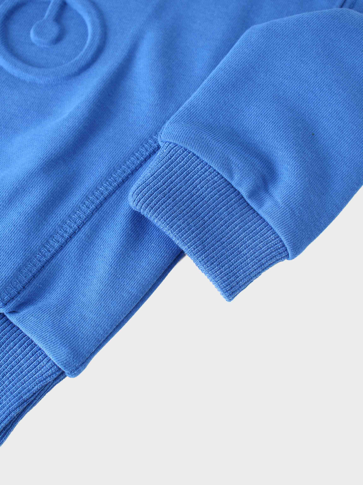 Royal blue bike sweatshirt sleeve with a ribbed cuff and visible seam.