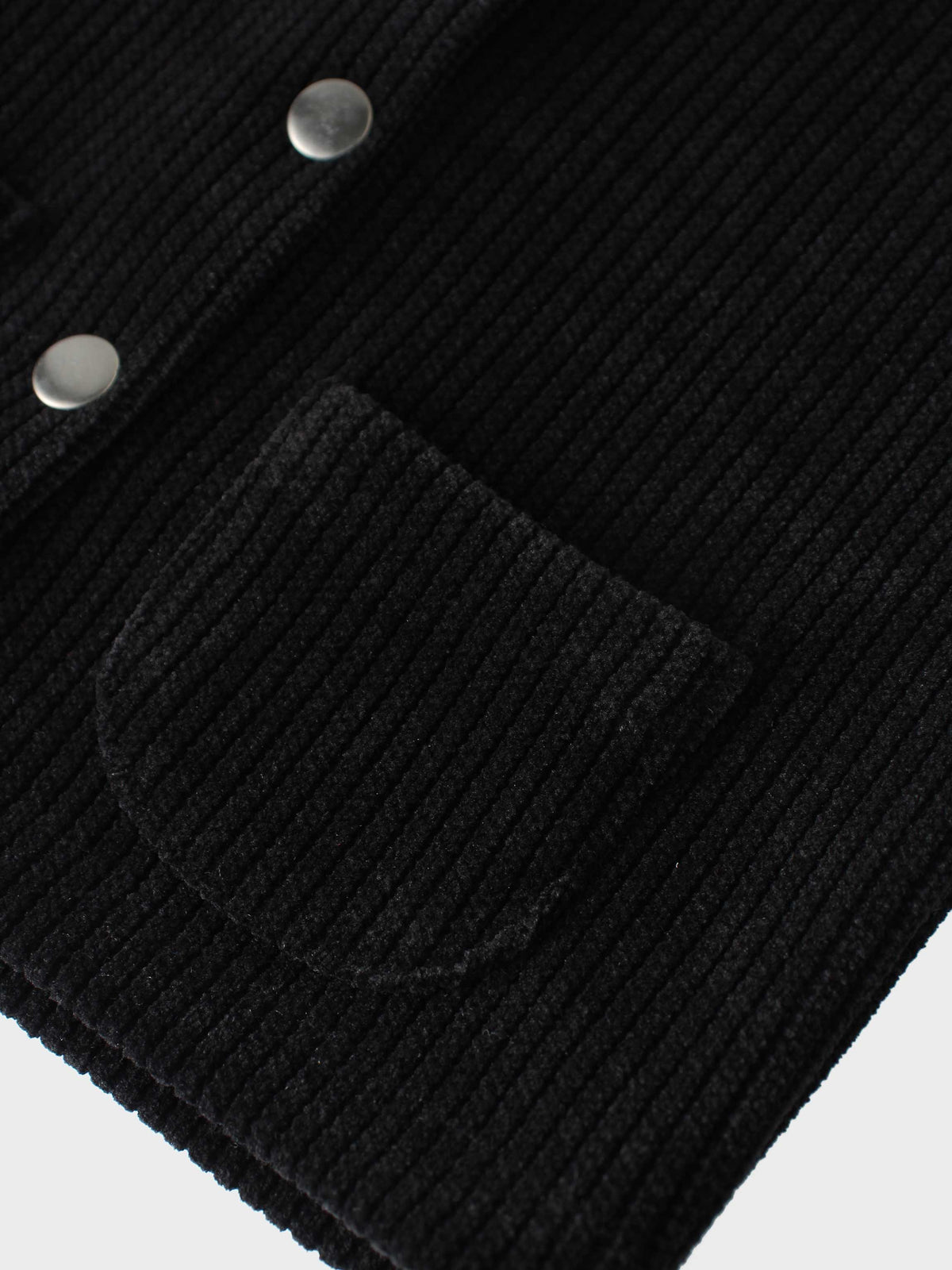 Corduroy jacket for girls in black by Adee; close-up shows textured fabric with metal snaps and pocket flap.