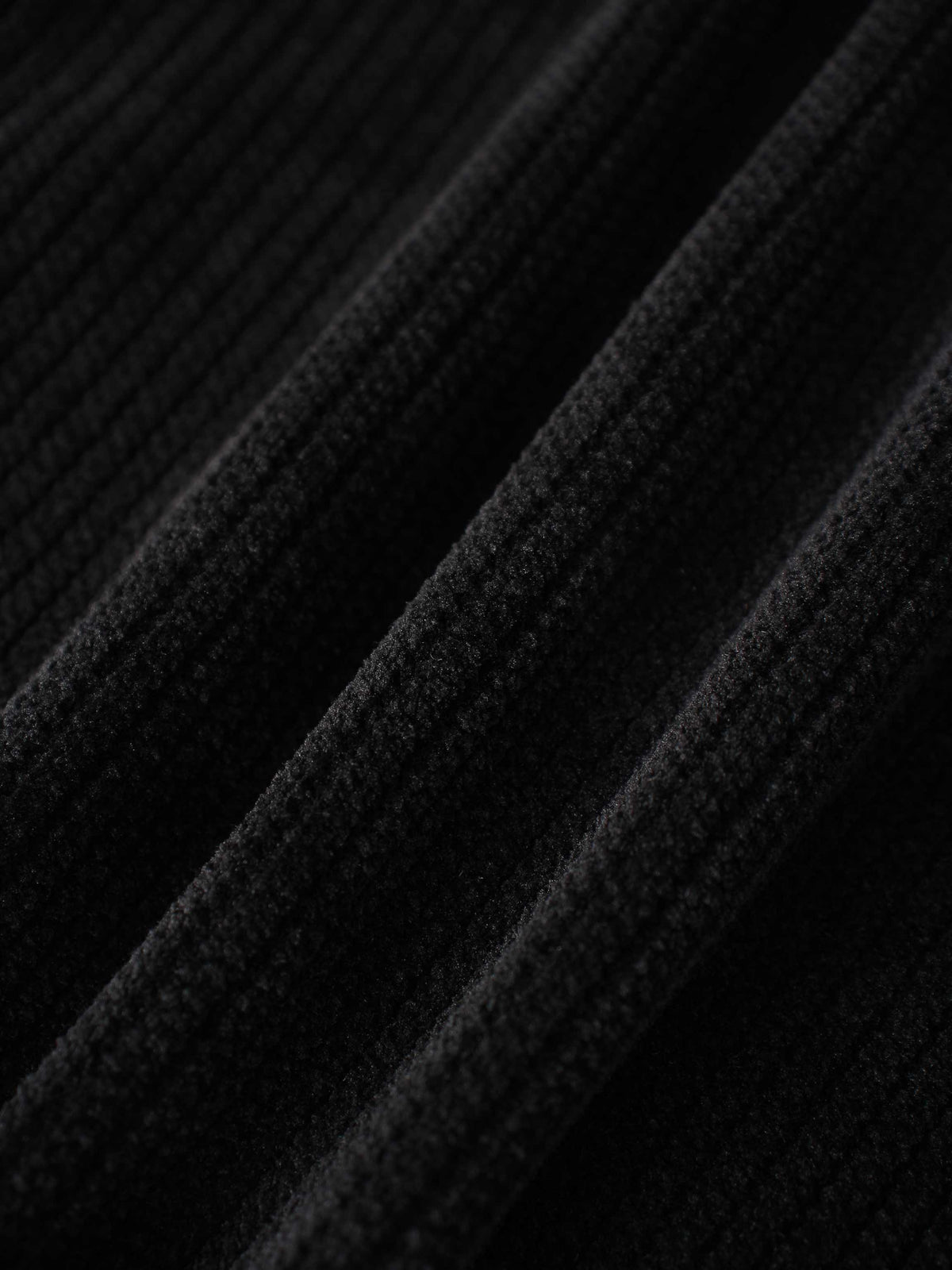 Corduroy jacket for girls, black; close-up of soft, textured fabric.