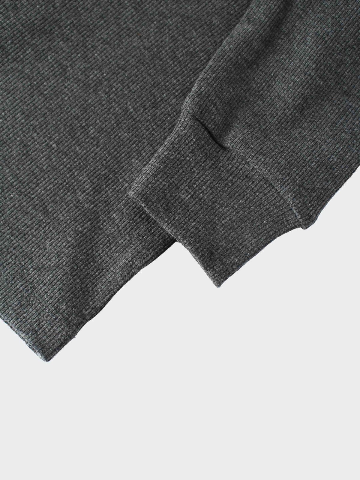 Grey ribbed puff-sleeve shirt sleeve cuff close-up in soft breathable knit fabric.