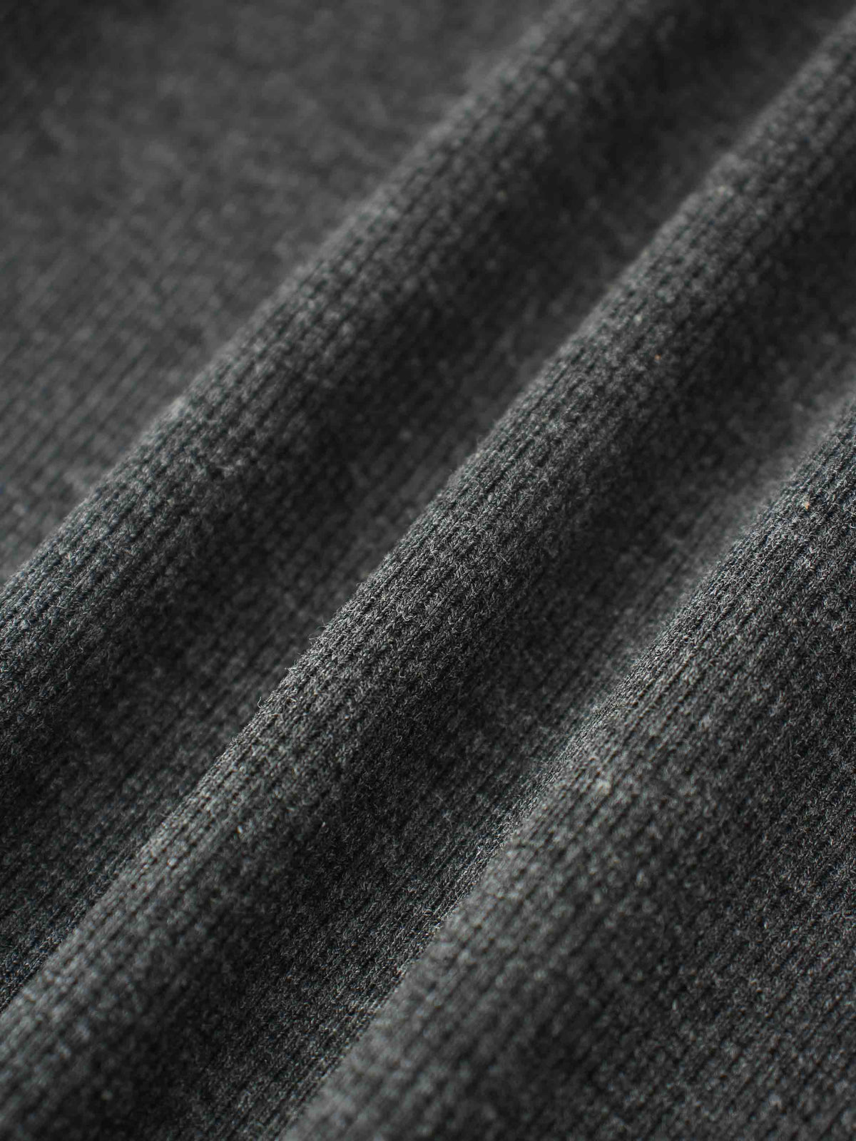 Close-up of soft grey ribbed knit fabric for a puff-sleeve shirt.
