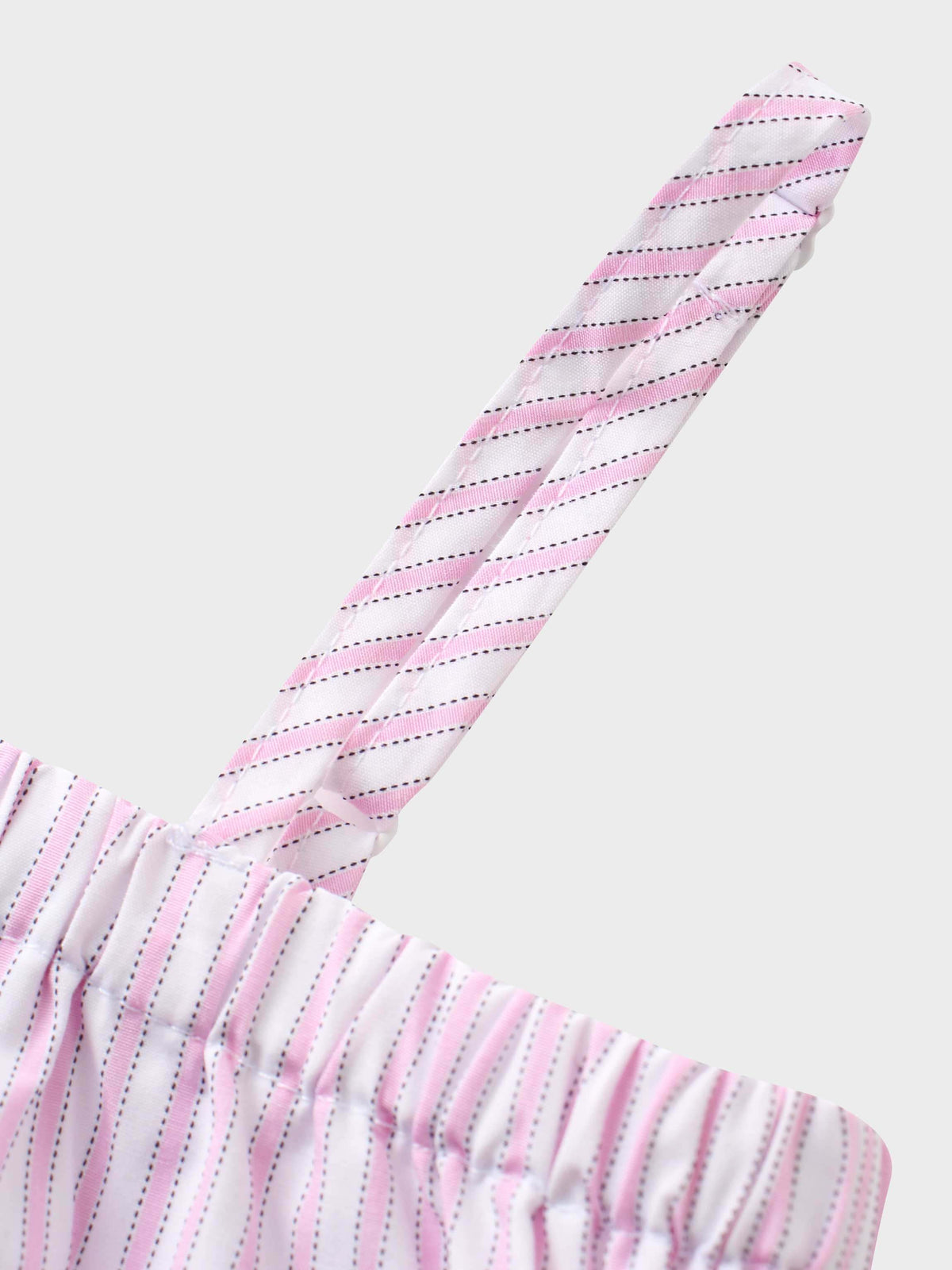 Pink and white striped cotton jumper strap with elastic top, close-up.