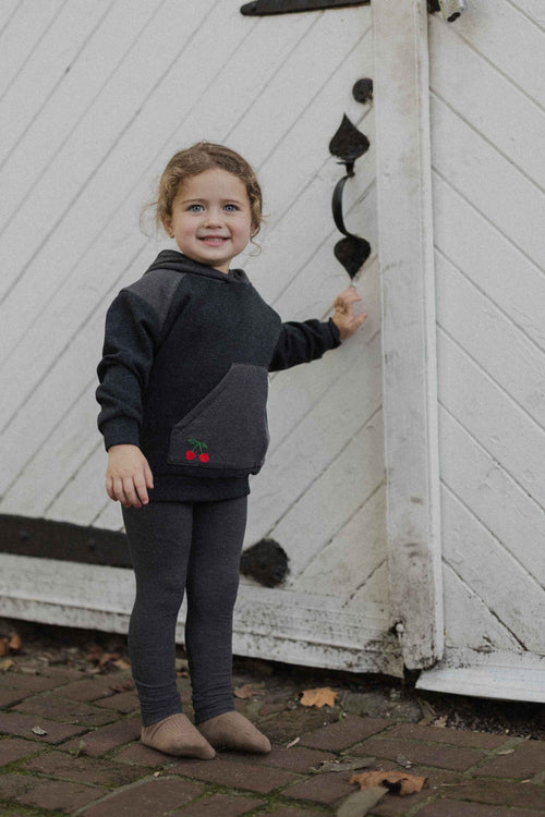 Girl in hoodie with leggings.