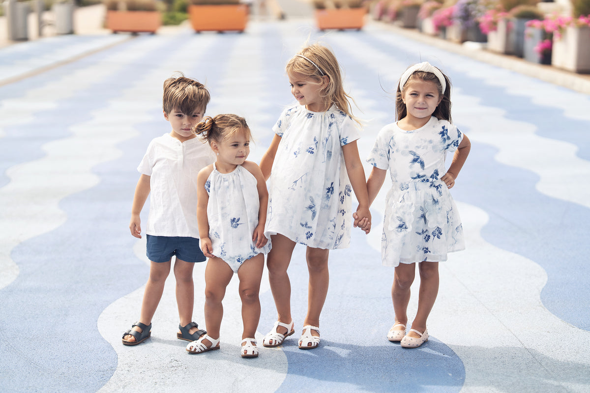 Blue Flower Romper for girls by Adee; dressy blue floral print on white.