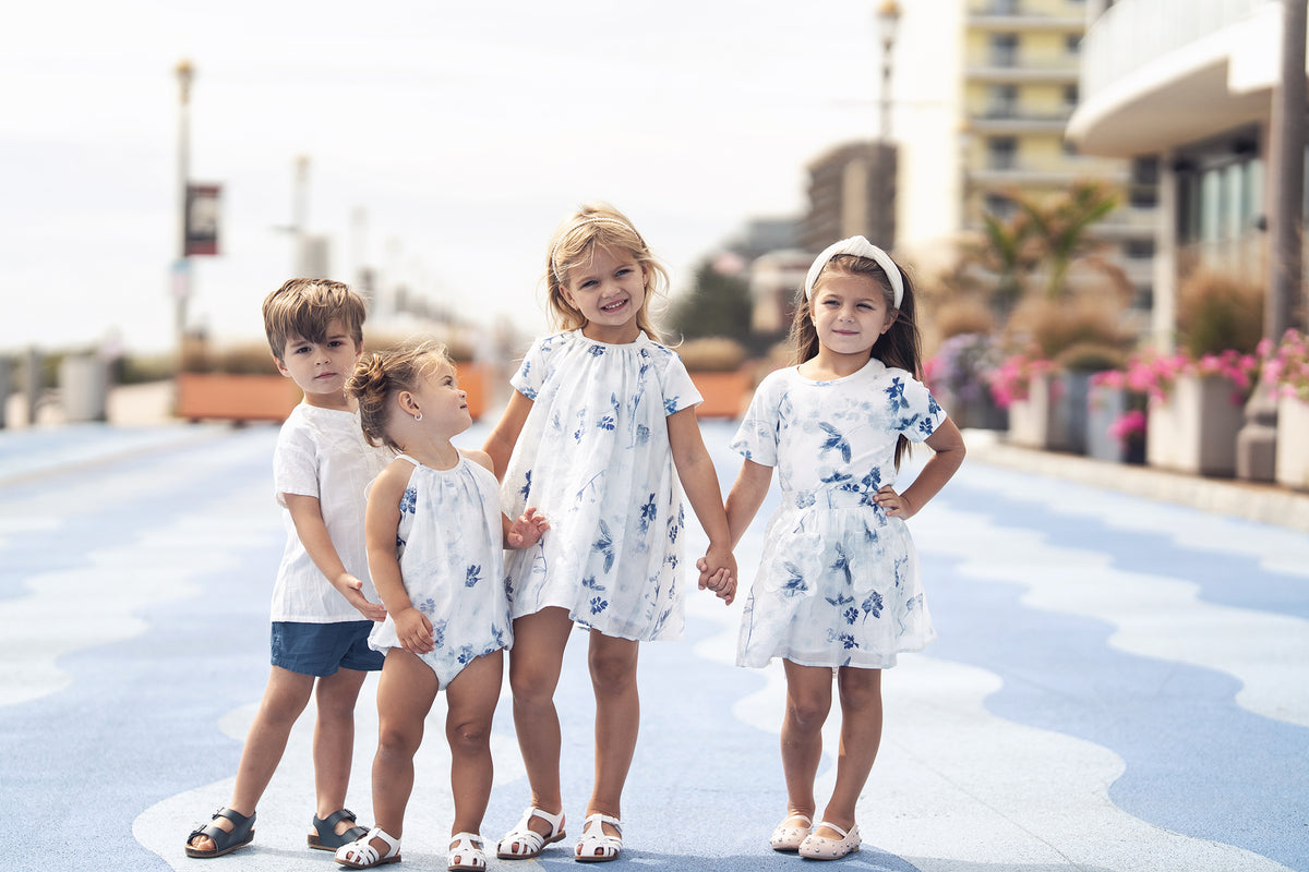 Blue Flower Romper for girls; five children in coordinating white and blue floral outfits.