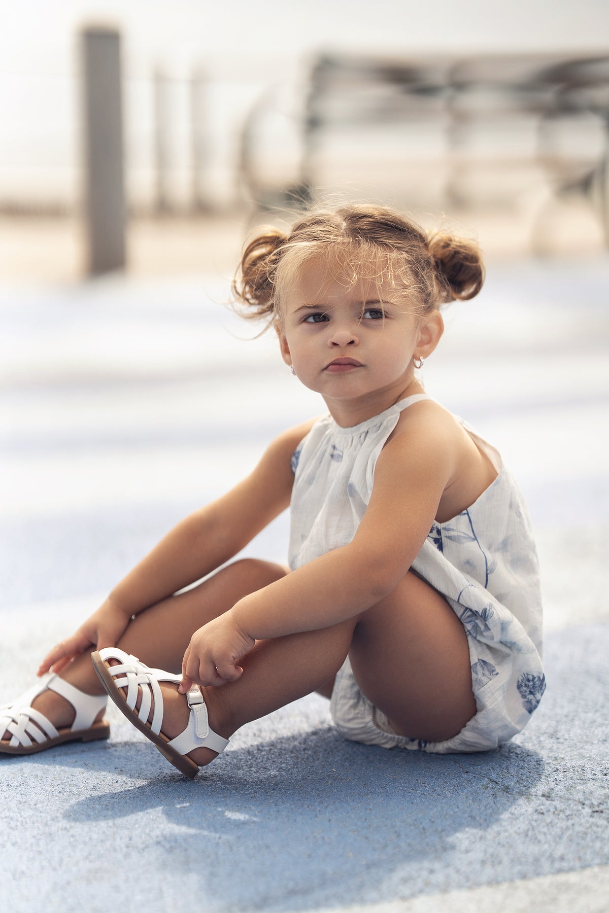 Blue Flower Romper for girls, dressy Adee apparel, white with blue floral print.