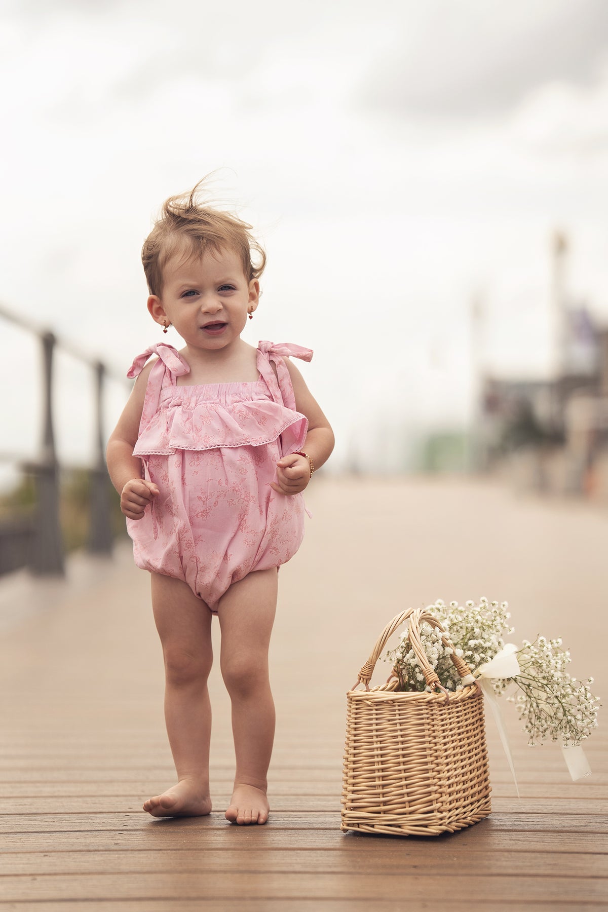 Pink Flower Romper for girls by Adee; dressy pink floral romper with tied shoulders and a ruffled top.