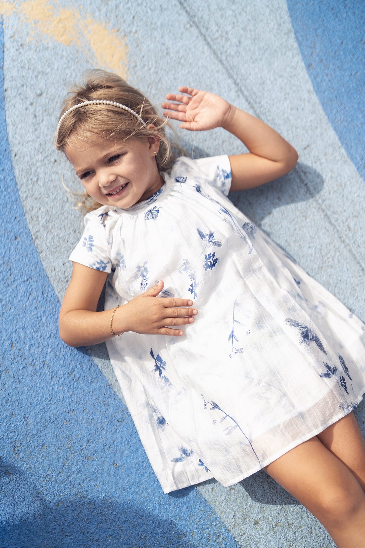 Blue Flower Jumper dress for girls, white fabric with blue floral print, dressy apparel.
