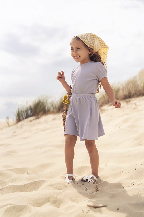 Circle Skirt - Lavender by Adee; girls circle skirt in lavender worn by a smiling child on the beach