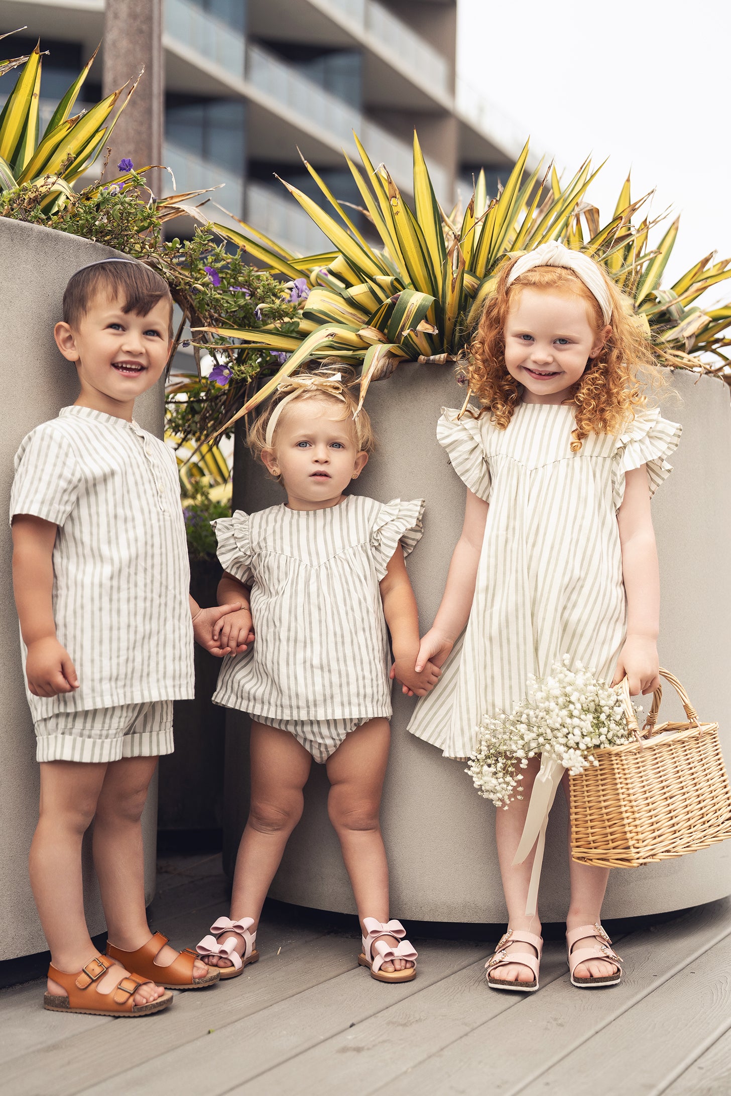 Adee green striped dress for girls; dressy apparel shown on three children