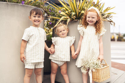 Green striped dress by Adee; girls dressy apparel, three children posing outdoors in matching striped outfits
