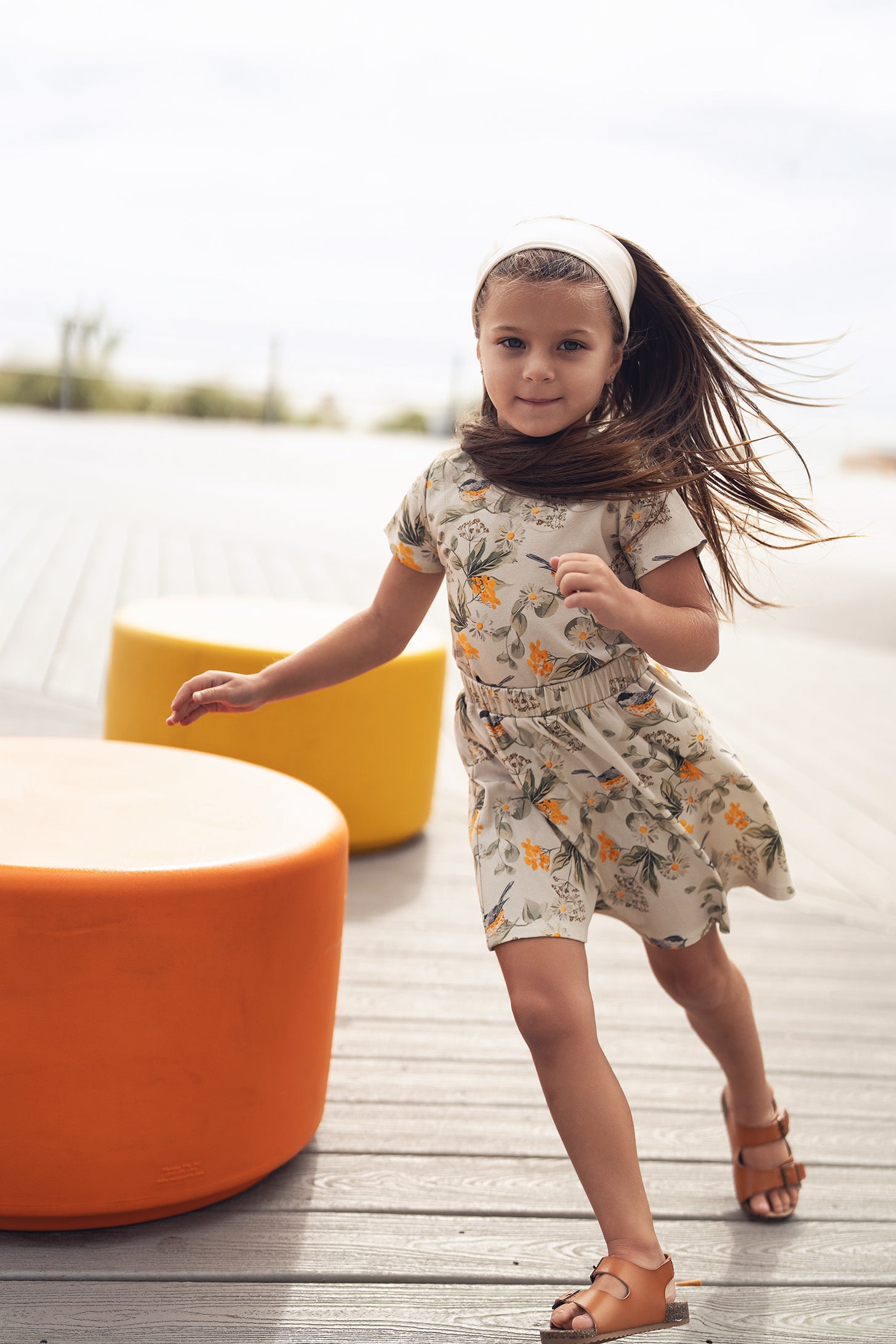Garden Finch Circle Skirt worn by a girl in a floral-print dress outdoors.