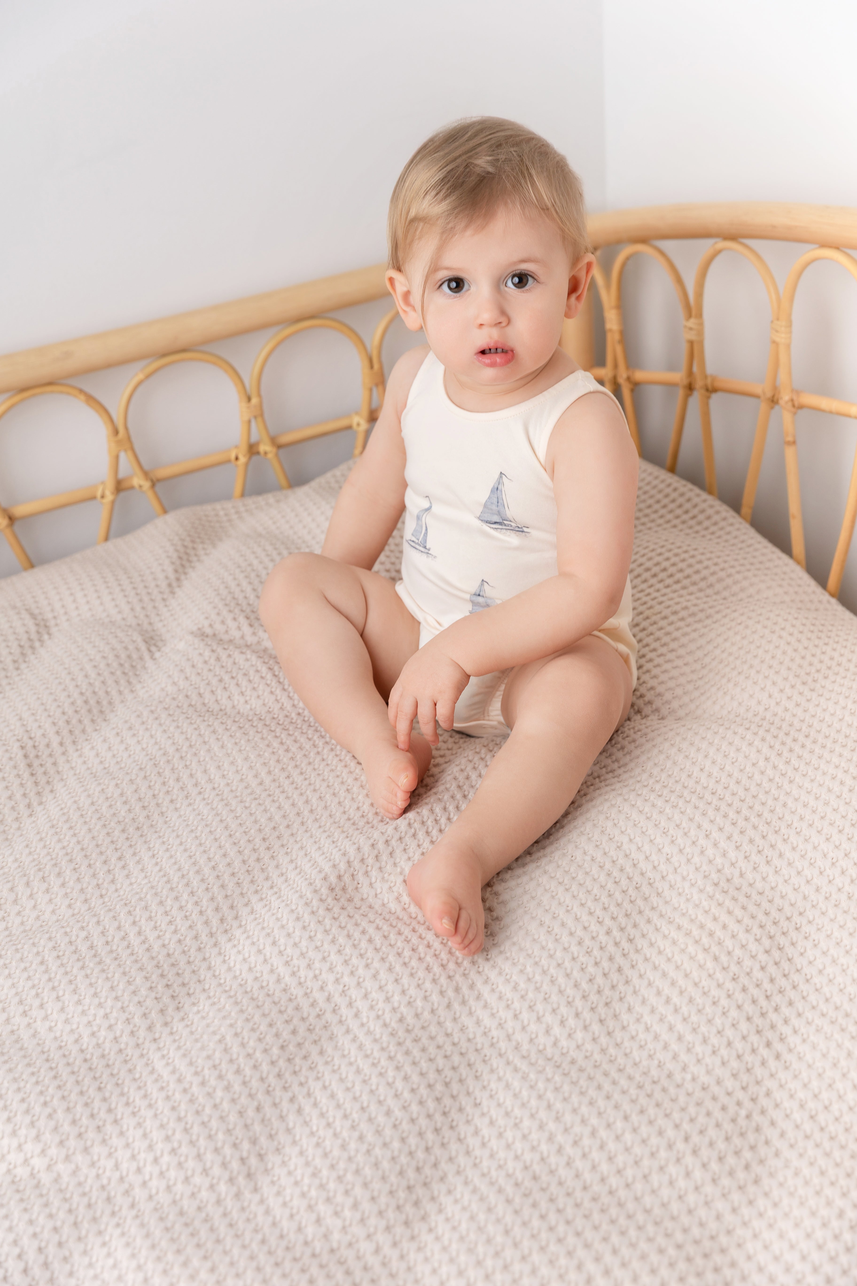Sail Boat Romper for boys by Adee, cream with sailboat print.