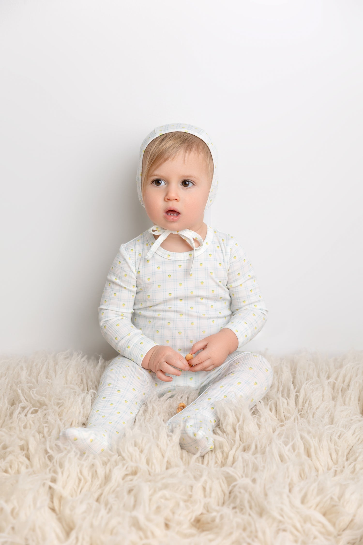 Lemon Window Stretchy boys stretchies by Adee on a crisp white base with yellow lemon dots.