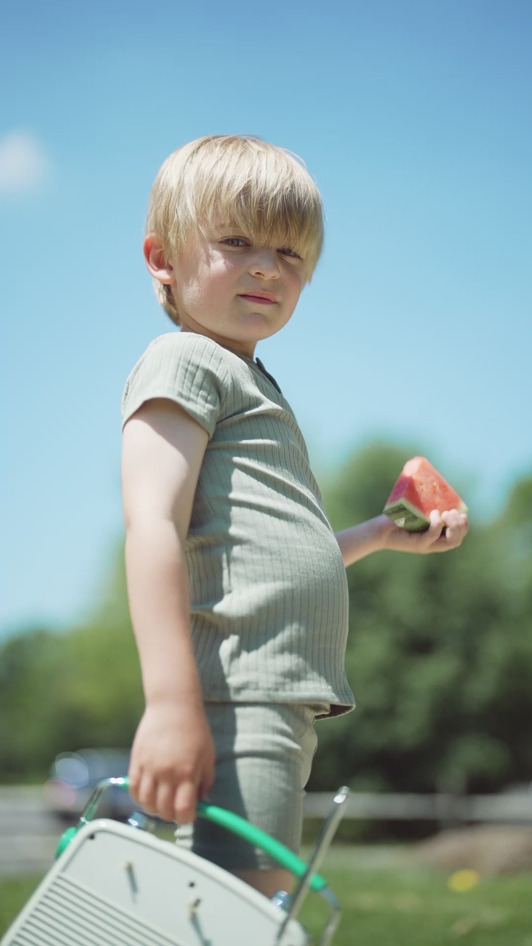 cute boy and girls wearing adee green and pink clothing eating watermelon 